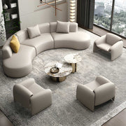 Modern living room with a curved sectional sofa and matching armchairs.